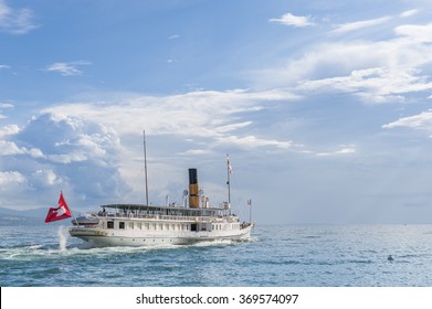 Small Steamboat Sailing On A Lake In Switzerland