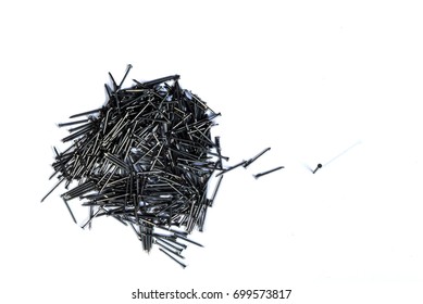 Small steel nails group isolated on the white background with have one steel nails separate from the group,Construction materials - Shutterstock ID 699573817