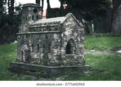 Small stone chapel structure in graveyard setting