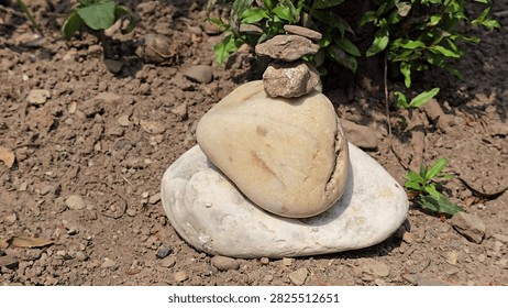 Small stone stack balanced on dry ground outdoors with zen like, meditation