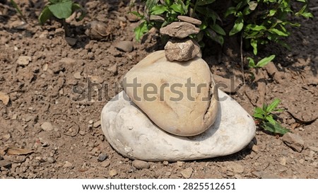 Small stone stack balanced on dry ground outdoors with zen like, meditation