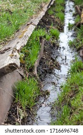 a small stream flows in a ditch
