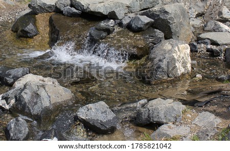 A small stream with a waterfall.