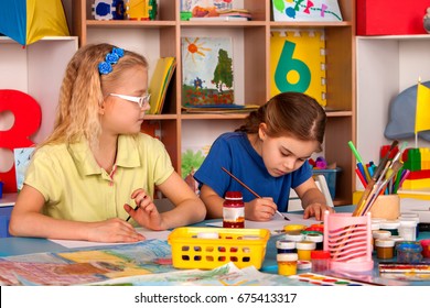 Small Students Painting In Art School Class. Child Drawing By Paints On Table. Girl In Kindergarten. Drawing Education Develops Creative Abilities Of Children. Childish Envy In Prep School.