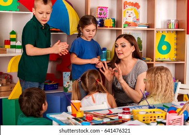 Small Students With Teacher Finger Painting In Art School Class. Break School In Painting Class. Mom And Kids At Home. Craft Drawing Education Develops Creative Abilities Of Children.