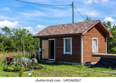 Small summer hut on plot of land in the country - Shutterstock ID 1492460267