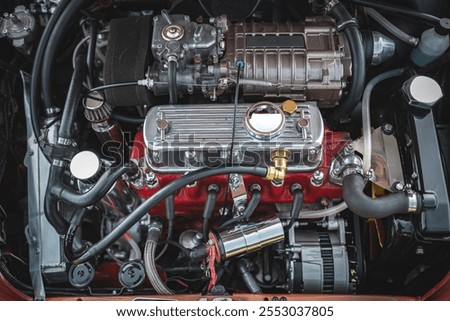 Small supercharged engine of a classic British car on a vintage car show