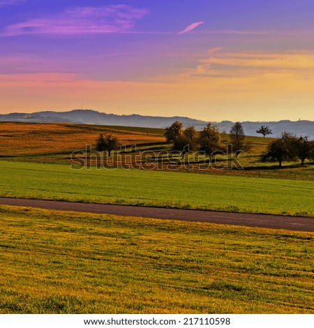 Similar – Image, Stock Photo Landscape with meadows, fields and trees in morning sun and fog