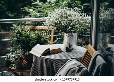 Small Table, Book And Flowers On A Beautiful Terrace Or Balcony