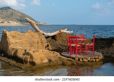 Small table and chairs on rock formation by the sea, Skyros island, Greece - Shutterstock ID 2197603043