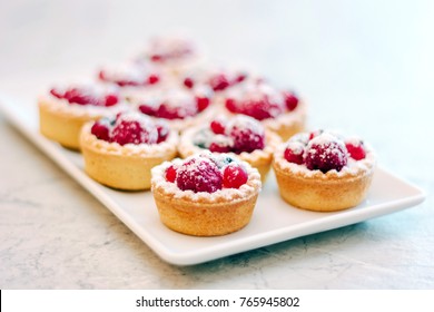 Small Tarts With Berries On White Plate.