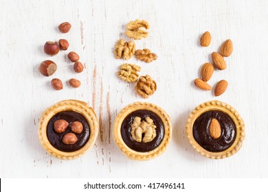 Small Tarts With Different Nuts And Chocolate, Top View