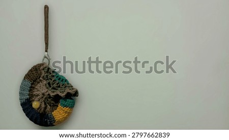 Small Textured Patchwork Yarn Bag and Wristlet Isolated on Light Background