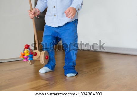 A small toddler boy, peeing in his pants, could not make it on time on the potty, child playing and forgetting to go pee. Kids potty traning