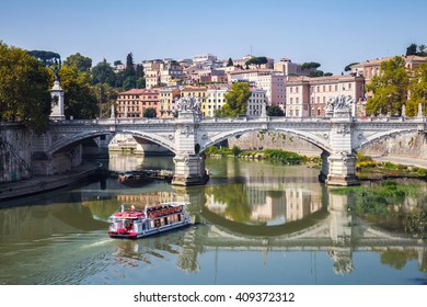 Small touristic boat goes to Ponte Vittorio Emanuele II. It is a bridge in Rome constructed to designs of 1886 by the architect Ennio De Rossi - Powered by Shutterstock