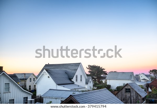 Small town America view of rooftops in early\
morning light. Copy space