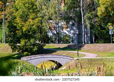 Small Town Landscape With Pedestrian Bridge And Paved Walkway