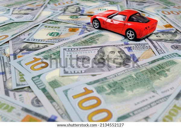 Small toy\
car and money. Loan and finance\
concepts