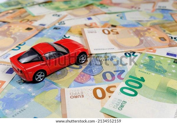 Small toy\
car and money. Loan and finance\
concepts