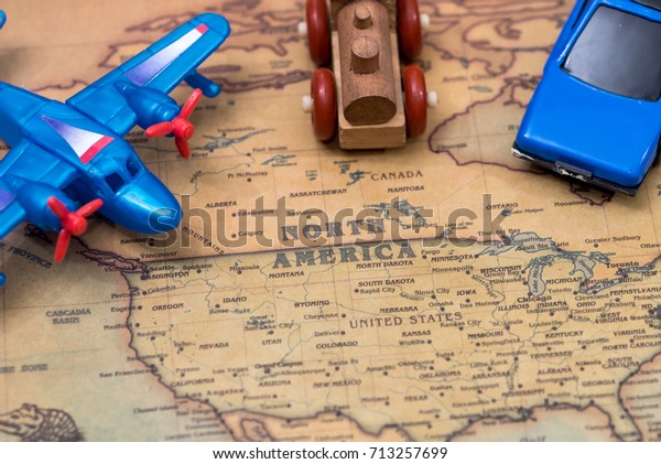small toy - car, plane\
and train on map