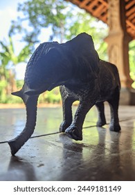 A small toy elephant in a cool rural setting