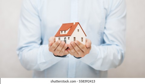 Small Toy House In Hands 