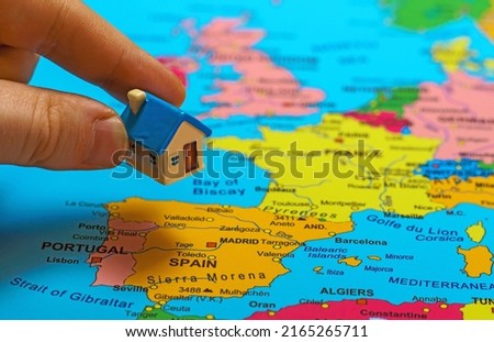 Small toy house on the map of Spain.