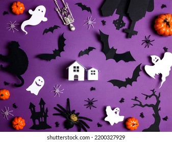 Small Toy House Surrounded By Halloween Decorations On Purple Background. Flat Lay, Top View.