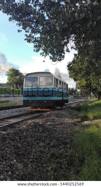Small train on the tracks. City train at\
sunset. Havana train\
transportation