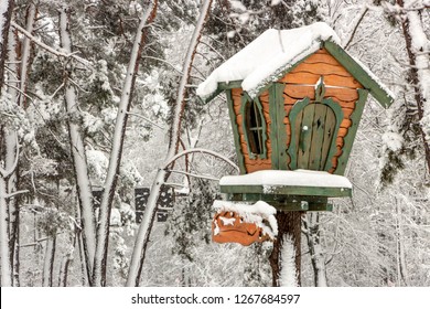 A small tree house in a snowy forest on a clear winter frosty day - Powered by Shutterstock