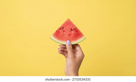 A small triangular slice of fresh watermelon held by a hand against a bright yellow background