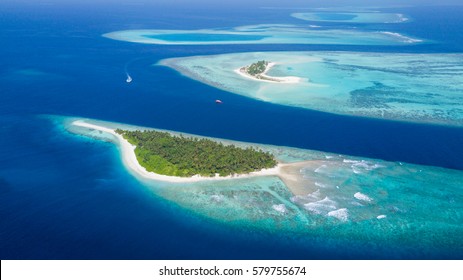 Small Tropical Island In Maldives Atoll From Aerial View