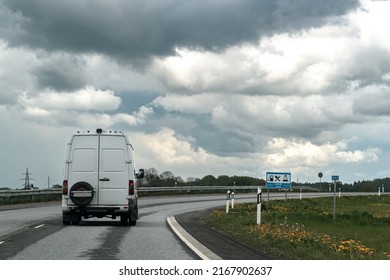 Small Truck Driving On An Asphalt Road. Small Truck Delivering Goods