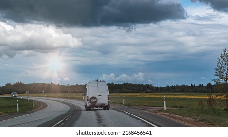 Small Truck Driving On An Asphalt Road. Small Truck Delivering Goods