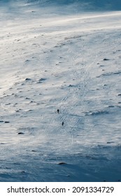 Small Two Mountaineer Hiking On Snow Covered Hill To The Top Of Mountain In Winter 