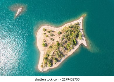 Small Uninhabited, Desert Sand Island With Many Trees In The Middle Of Sea. Drone View, Aerial View, Top View