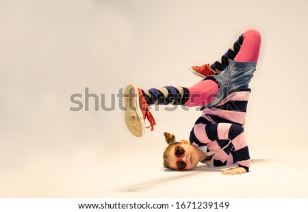 small unique dancer, girl in a difficult break dance position