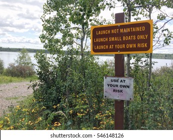 Small Unmaintained Boat Launch with Warning Signs