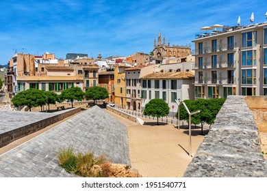 Small Urban Park And Colorful Houses Of The Old City Under Blue Sky In Palma, Spain.