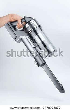Small vacuum cleaner with narrow nozzle side view isolated on white studio background