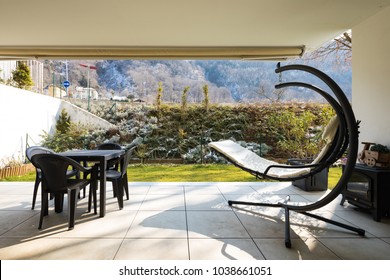 Small Veranda With Garden Furnished With Outdoor Furniture. Winter Day