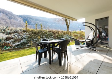 Small Veranda With Garden Furnished With Outdoor Furniture. Winter Day