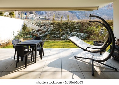 Small Veranda With Garden Furnished With Outdoor Furniture. Winter Day