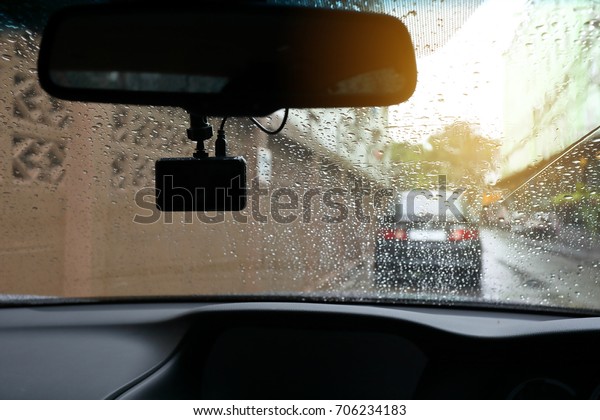 small video camera record
inside motor vehicle on windshield, drive car road trips in rainy
day weather