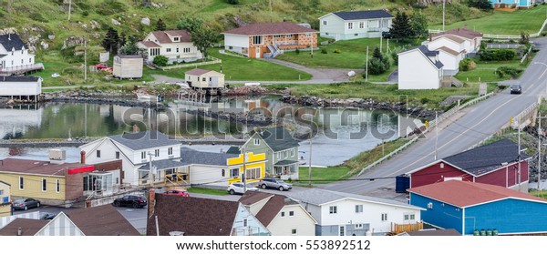 Small village and\
community buildings in Twillingate, Newfoundland.  Homes along\
shoreline in this coastal village, local roads connect the\
community along the Island\'s\
edges.
