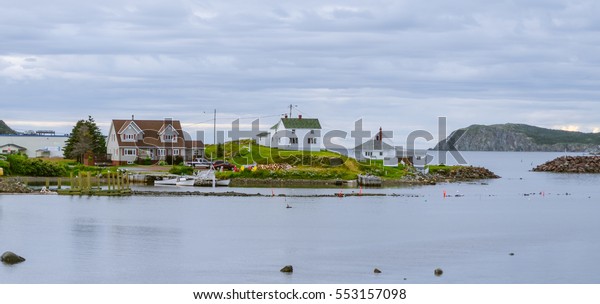 Small village community, Twillingate,\
Newfoundland.  Homes along shoreline.  Boats & dories at docks\
in a small cove.  Woodpile bears witness to coming cold.  Hardy\
community along the Island\'s\
edges.