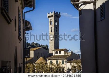 Small village in Italy. Mountain village landscape. Hills background. North of Italy. Fiesole city viewpoint. Church in valley. Oldtown tower with clock.