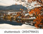 Small village with a lake and mountains in the autumn colours