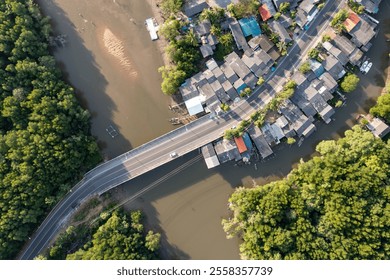 A small village nestled amidst lush mangrove forests and a winding river.Satun, Thailand. Aerial view landscape. - Powered by Shutterstock