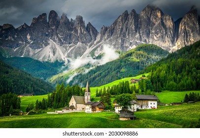 Small village on mountain hill in Alps - Shutterstock ID 2030098886